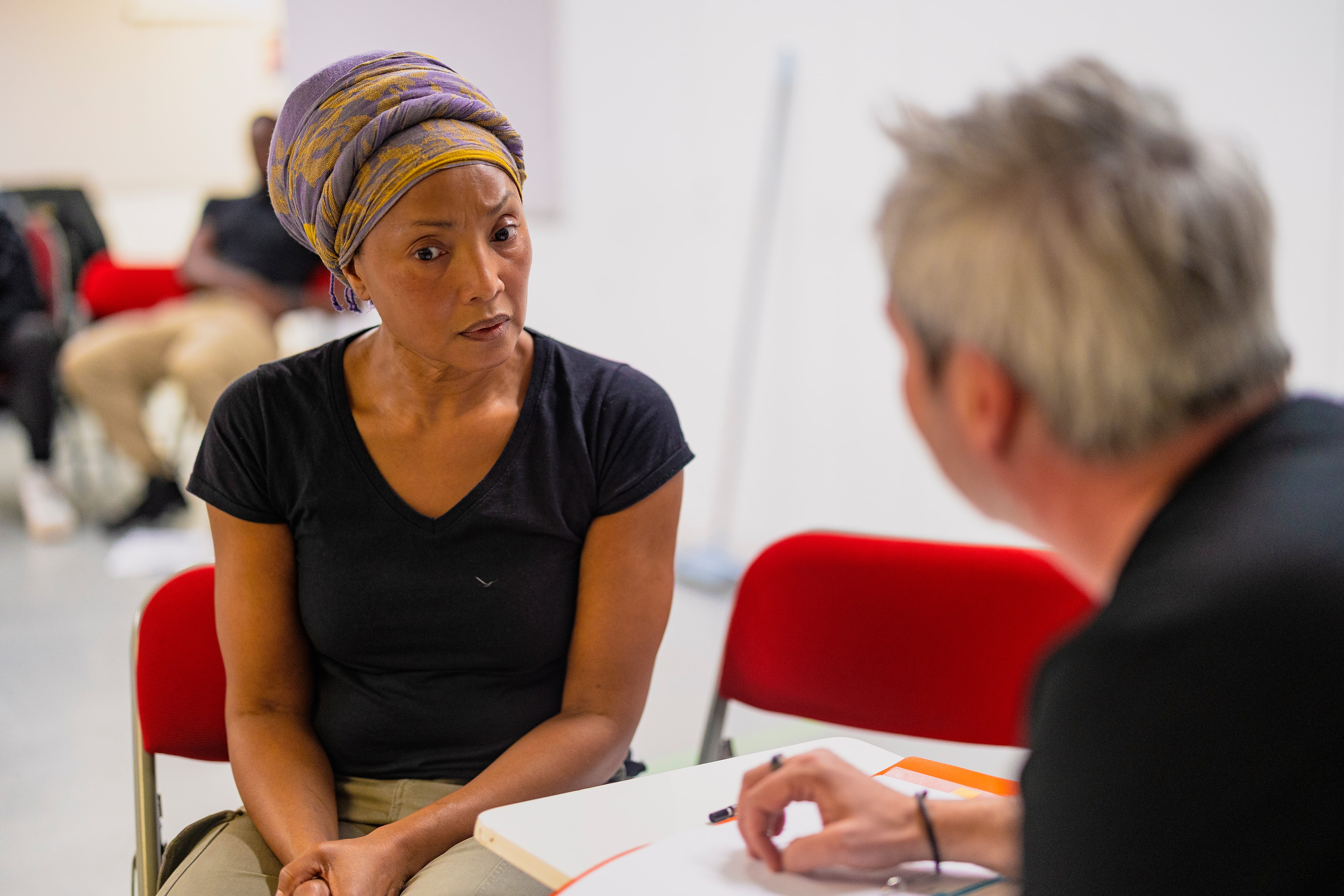 Cast member in conversation during rehearsal workshop
