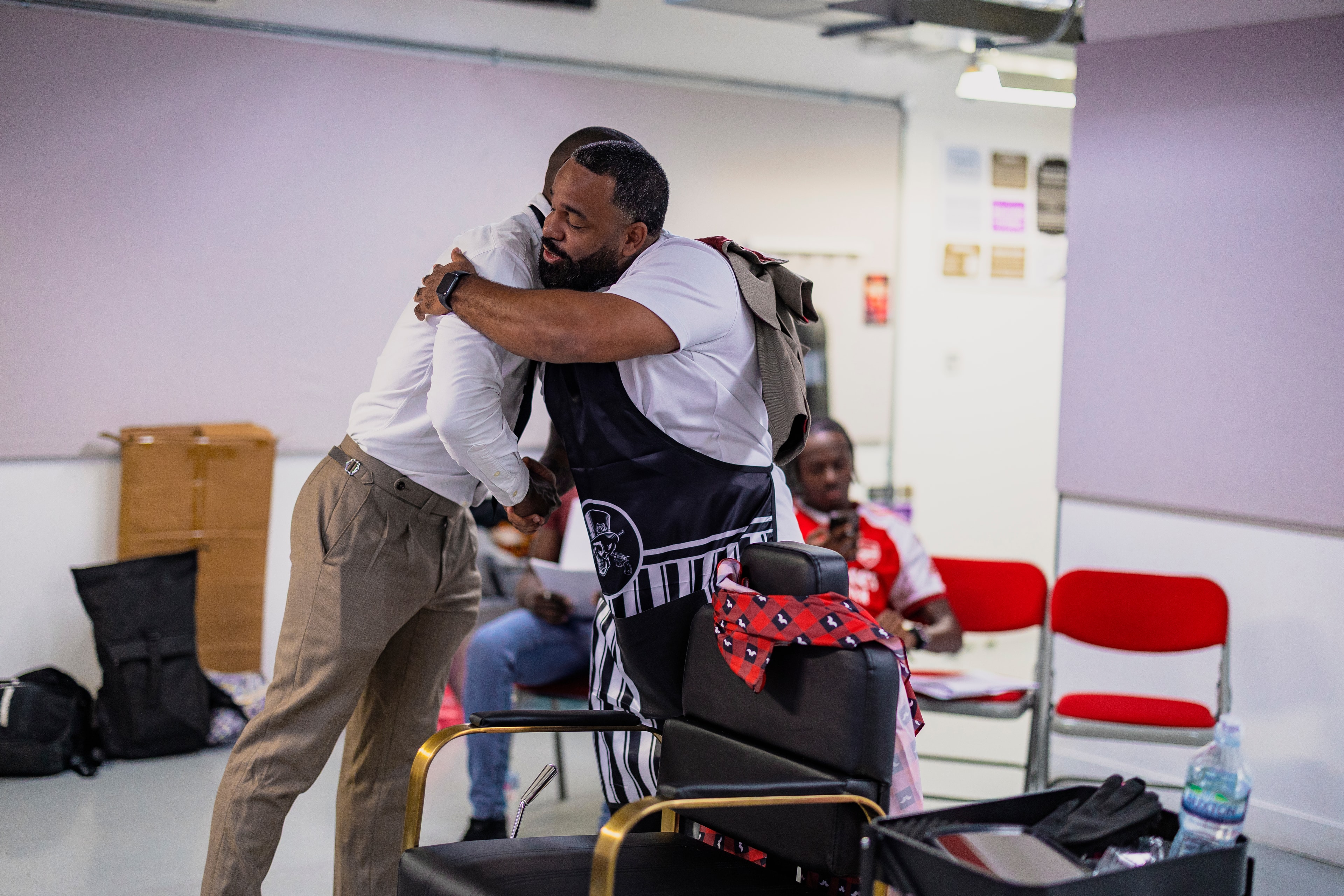 Cast member in the barbershop chair during rehearsal